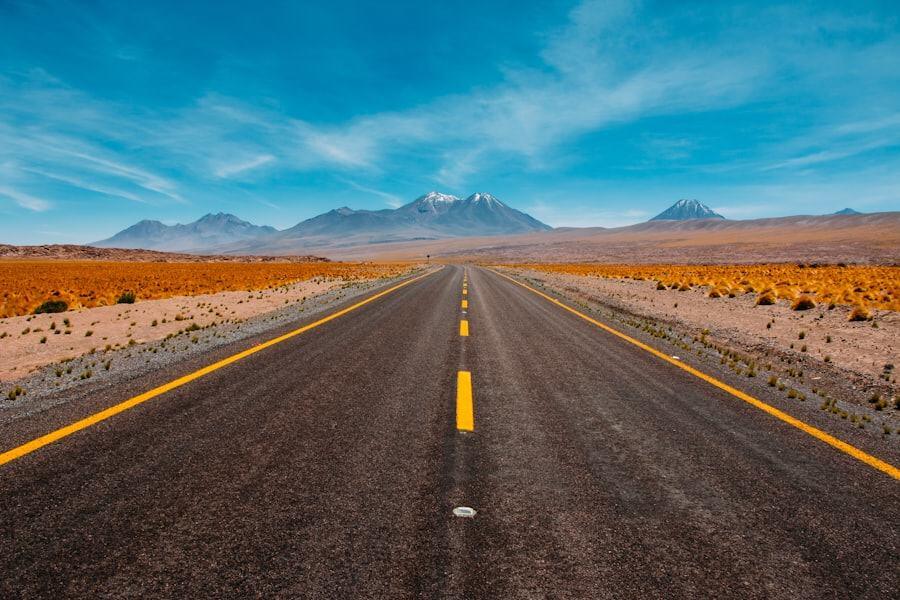 Estrada reta atravessando o deserto em direção às montanhas